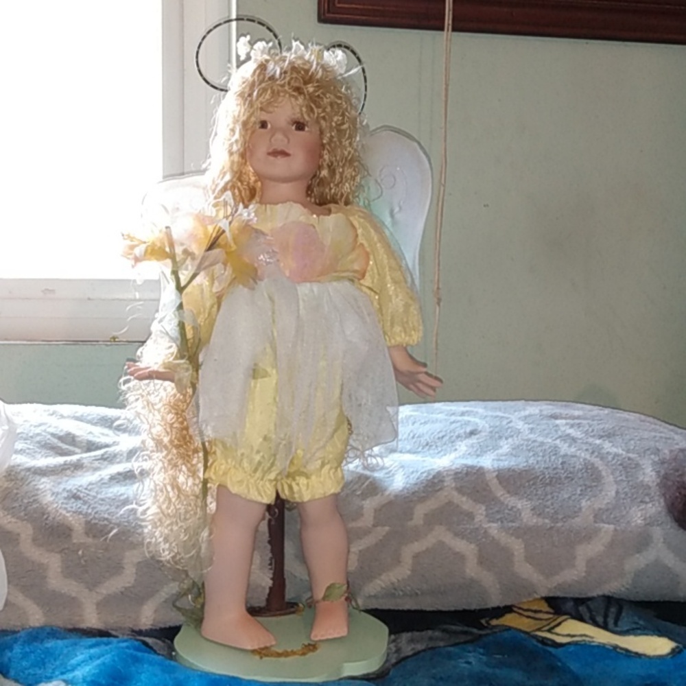 Porcelain Girl Doll with wings and stand.